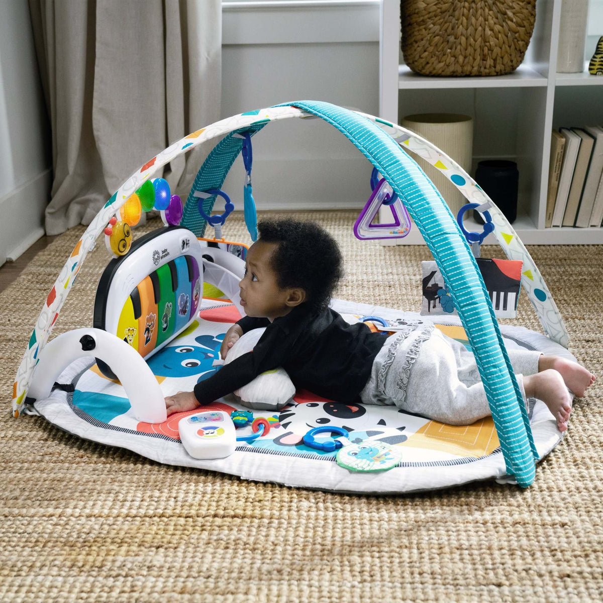 3-6 months baby playing with colorful developmental toys for sensory and motor skill growth