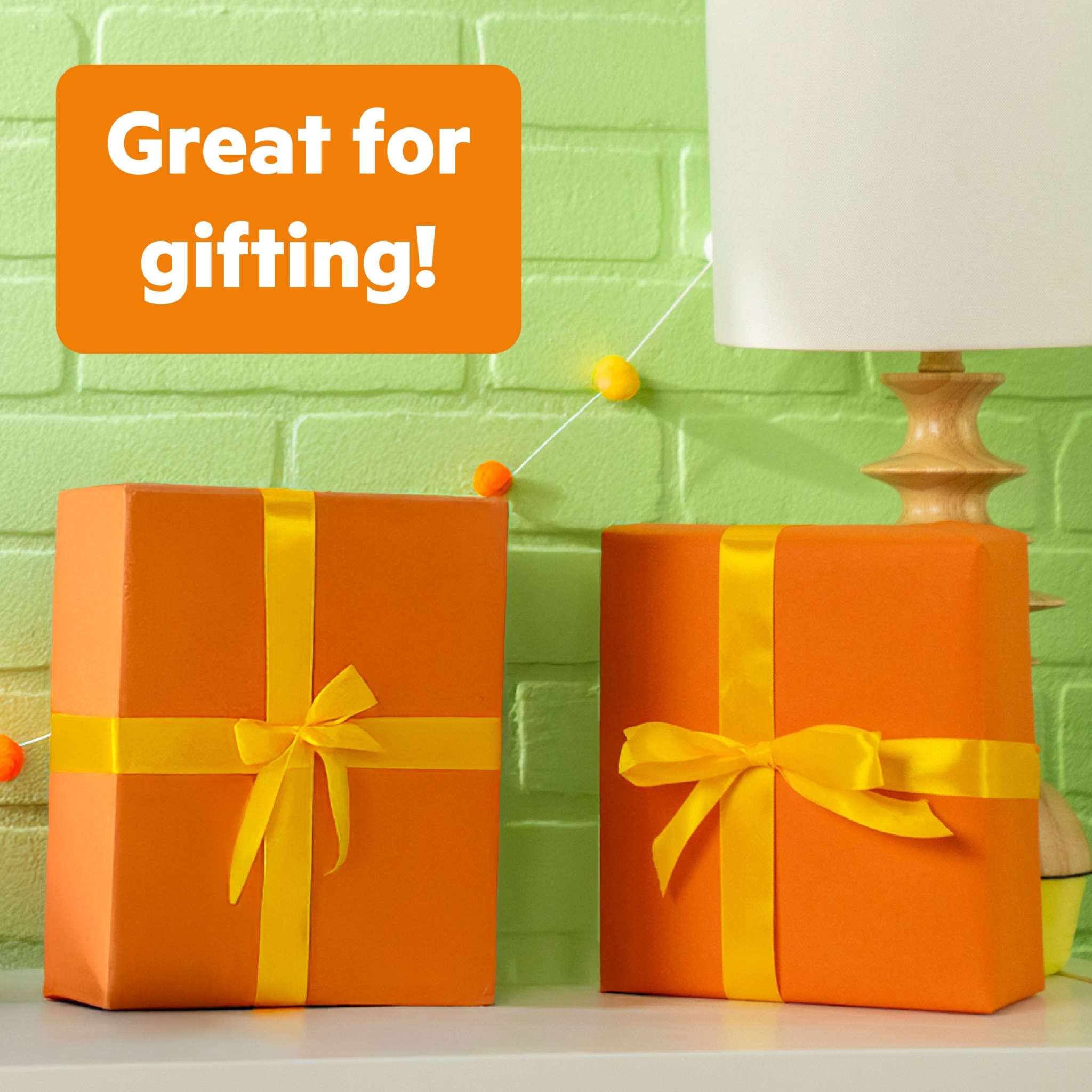 Bright Starts Wobble & Rattle Gift Set with two orange gift boxes wrapped with yellow ribbons labeled great for gifting