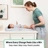 Ingenuity CozyClean Changing Pad with wipeable vinyl surface and removable machine-washable taupe cover on a changing table