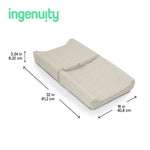 Ingenuity CozyClean Changing Pad with water-resistant vinyl surface and removable washable cover in taupe on nursery changing table