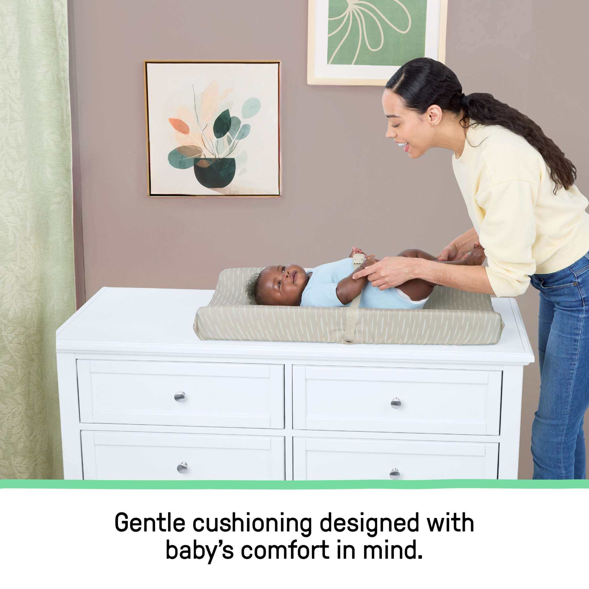 Ingenuity CozyClean Changing Pad taupe with wipeable vinyl surface and removable machine-washable cover on changing table