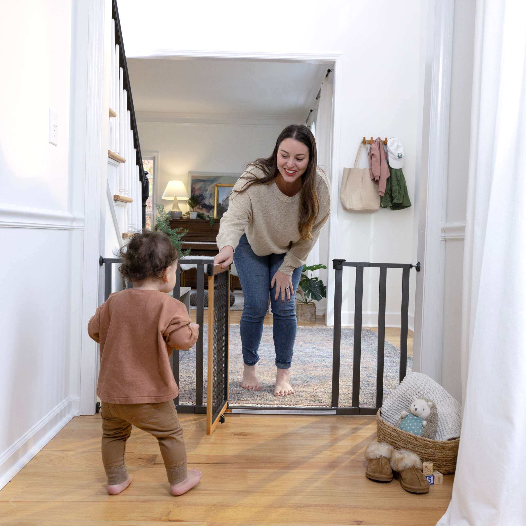 Ingenuity Thruway 60XW Series pet and baby safety gate with honey oak wood frame and metal bars
