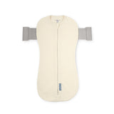Cream-colored baby swaddle with gray straps on a white background
