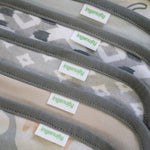 Close-up of a product with 'ingenuity' labels on a camouflage-patterned background