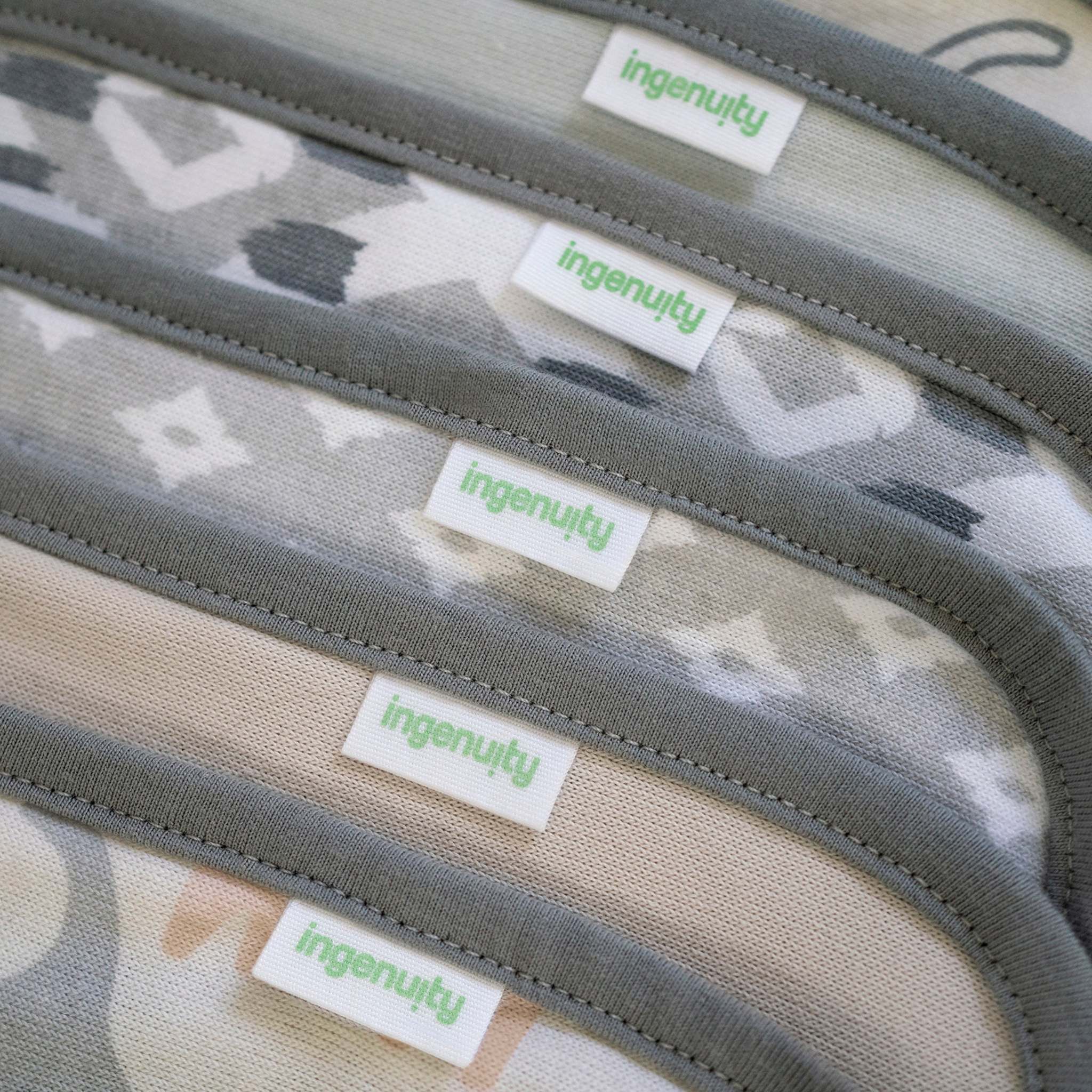 Close-up of a product with 'ingenuity' labels on a camouflage-patterned background