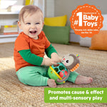 Baby playing with Bright Starts Giggle & Rattle Gift Set monkey toy promoting sensory and cause-effect play