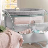 Ingenuity Dream & Grow Bedside Bassinet with breathable mesh sides, adjustable height, lockable wheels, and soothing night light