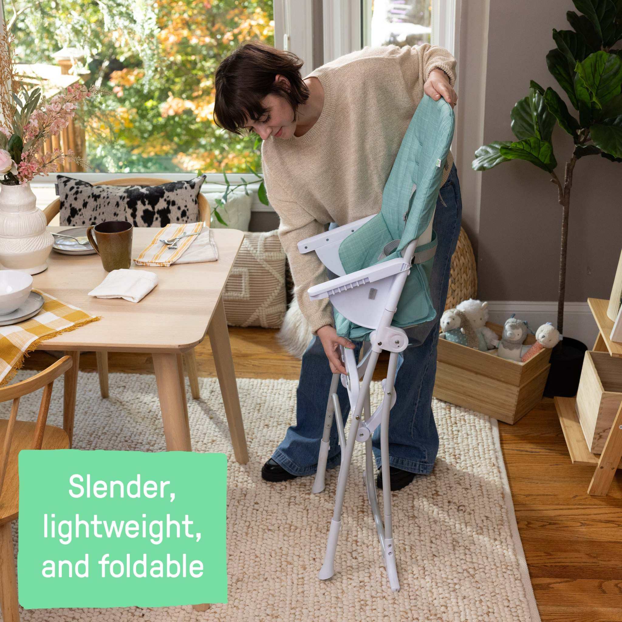 Ingenuity Sun Valley compact folding teal high chair with adjustable tray and 5-point harness for babies