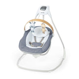 Ingenuity SimpleComfort Compact Soothing Swing in chambray with rotating wooden toy bar and 6-speed settings