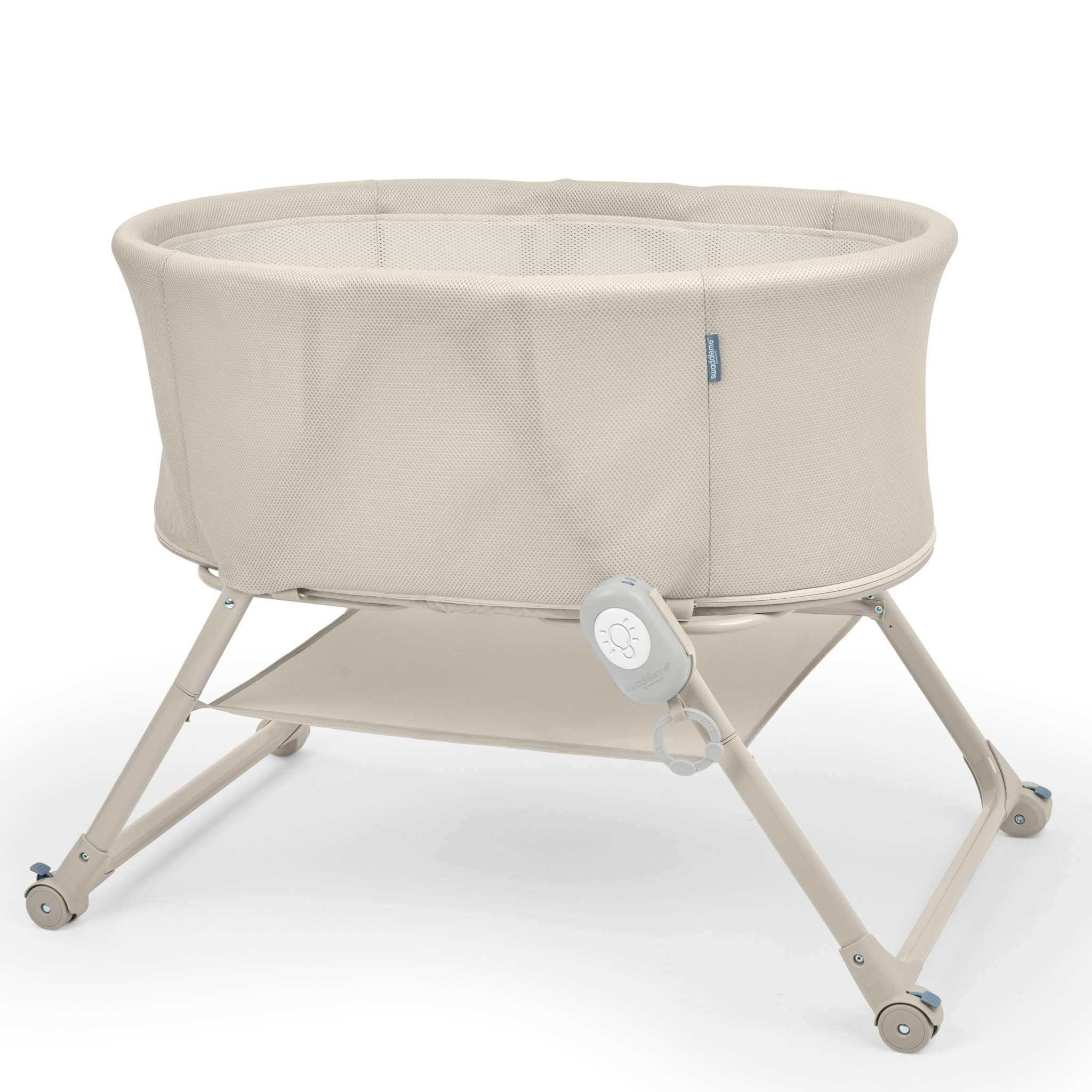 Ingenuity Snooze & Stow™ easy-folding bassinet with sound, light, vibration, mesh sides, and storage shelf in sand color.