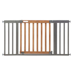 Ingenuity The Thruway 60W Series baby and dog safety gate with honey oak wood door and metal frame installed in doorway