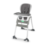 Gray high chair with a green tag on a white background