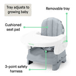 Ingenuity Deluxe Comfort folding baby booster seat in grey with adjustable tray and padded seat