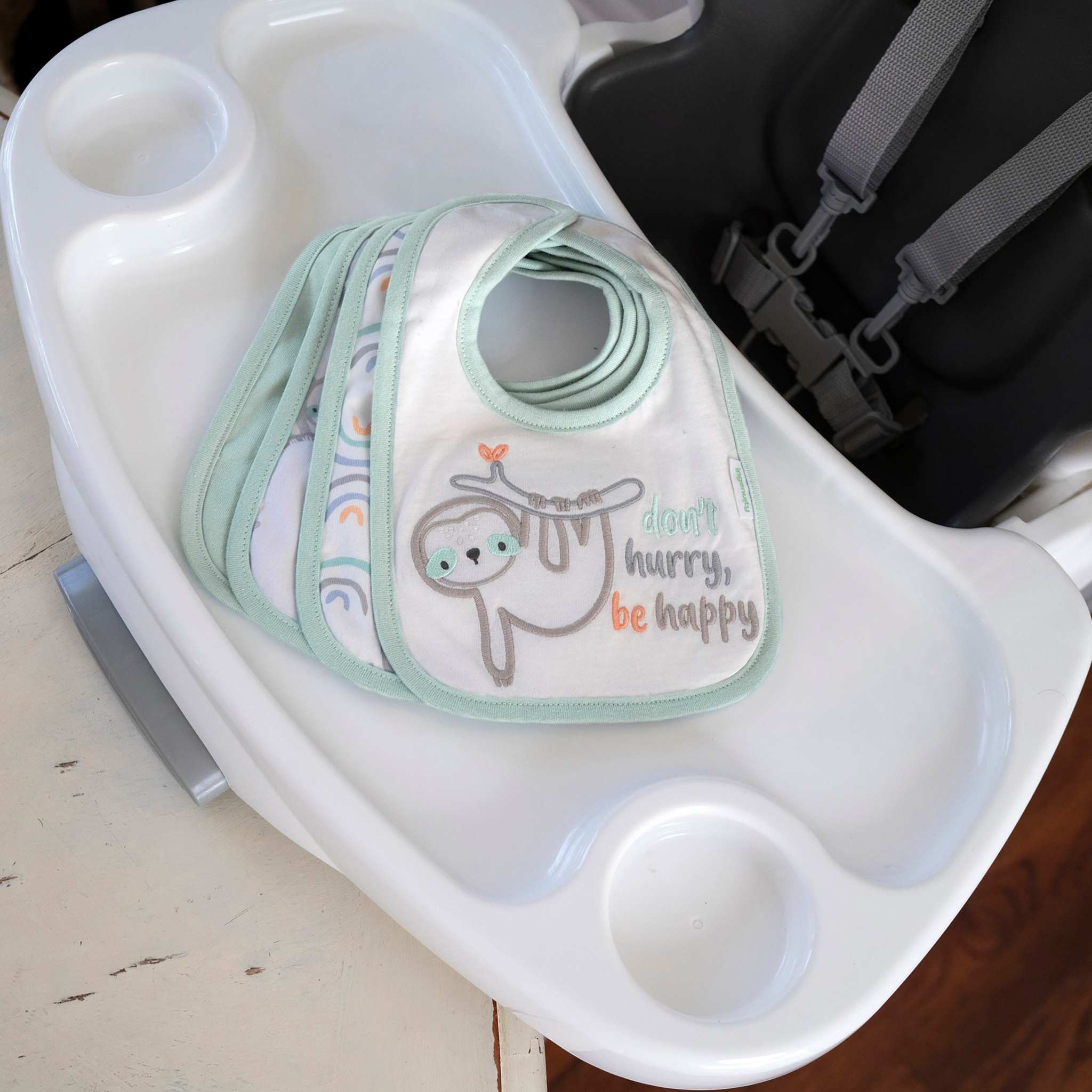 Ingenuity Easy Eater 4-Pack absorbent cotton baby bibs with playful animal and nature prints