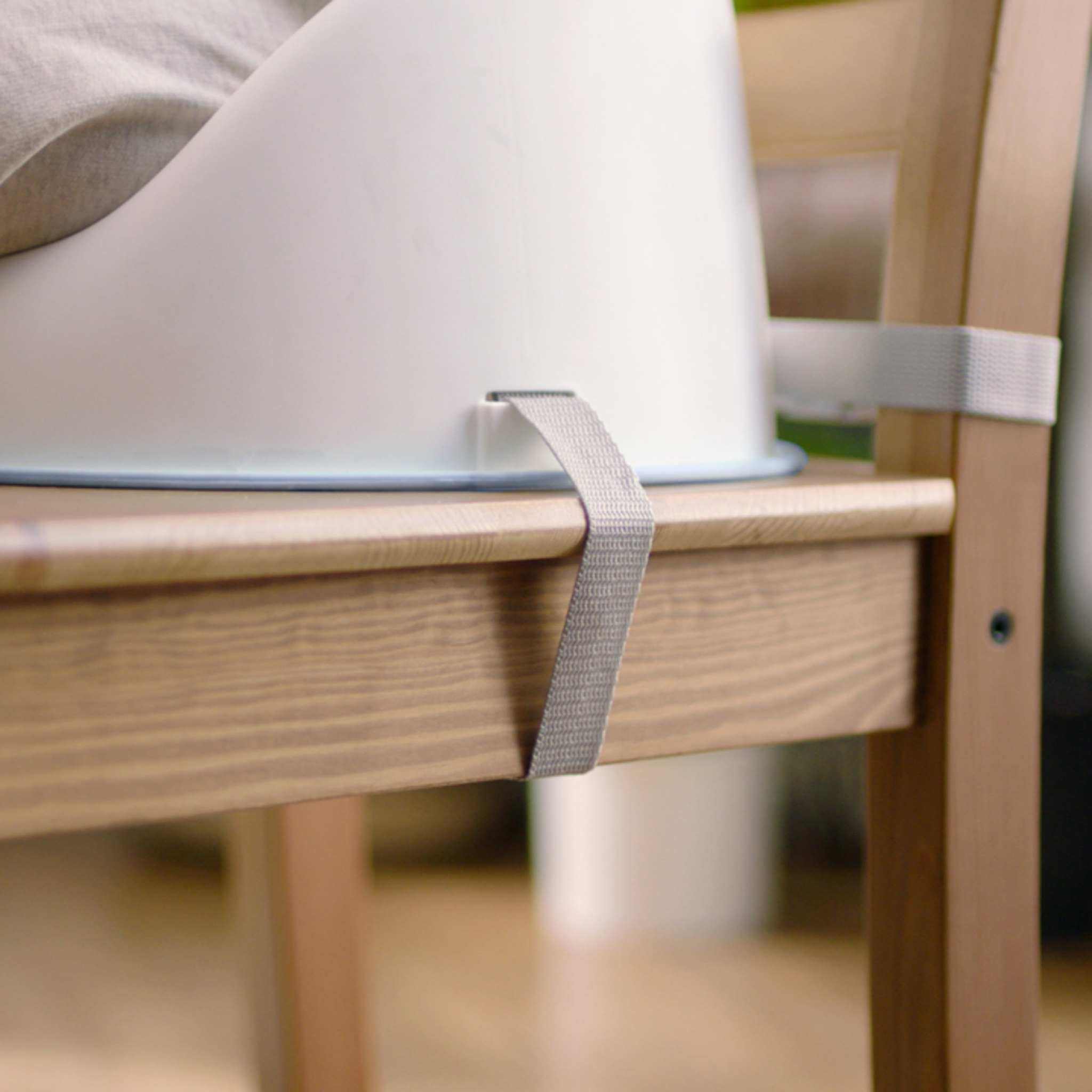 Grey Ingenuity Simplicity Seat Easy-Clean Baby Booster Seat attached to dining chair with washable straps