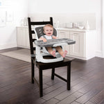 Ingenuity SmartClean ChairMate high chair and toddler booster seat in slate attached to dining chair with wipeable tray and safety straps