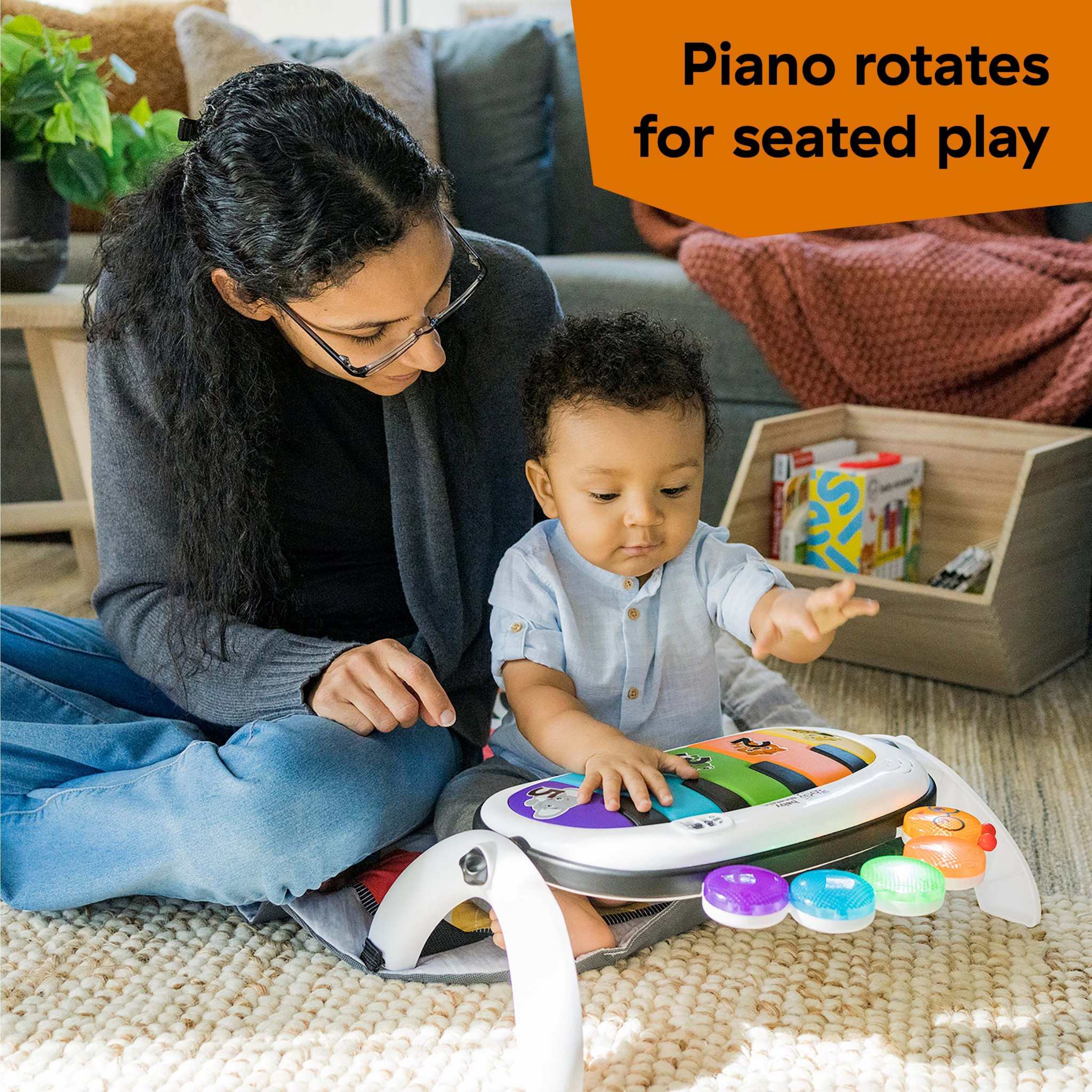 Baby enjoying the Baby Einstein 4-in-1 Kickin’ Tunes Music & Language Discovery Gym with rotating piano for seated play.