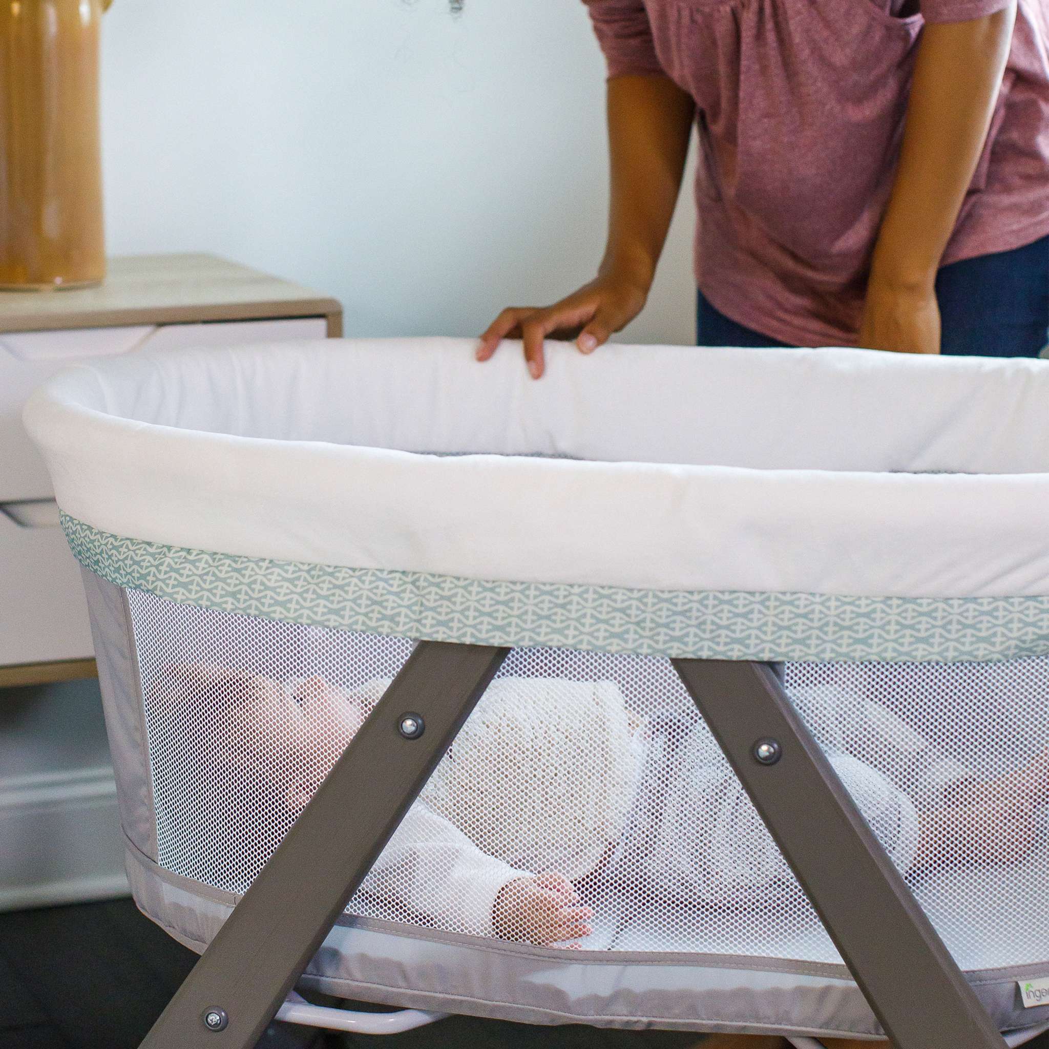Ingenuity Wood FoldAway Rocking Bassinet with breathable fabric and foldable design for easy portability and baby comfort