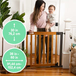 Ingenuity The Thruway 60W Series safety gate with honey oak wood door and metal frame for baby and pet containment